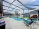 Inviting screened-in pool with ample seating and sun loungers, perfect for outdoor relaxation and entertaining at 1364 Rebecca Dr, Haines City, FL 33844