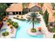 Aerial view of a resort-style pool with seating, umbrellas, palm trees, and clubhouse at 1375 Tuscana Ln # 1405, Davenport, FL 33896