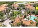 A beautiful aerial view of the condo community featuring a luxurious pool and verdant landscaping at 1375 Tuscana Ln # 1405, Davenport, FL 33896