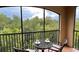 Cozy balcony with seating and a view of the green trees at 1375 Tuscana Ln # 1405, Davenport, FL 33896