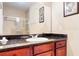 Well-lit bathroom featuring a granite countertop, a large mirror, and a shower with glass door at 1375 Tuscana Ln # 1405, Davenport, FL 33896