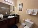 Well lit bathroom featuring dark countertops, a dark-wood vanity, and a shower with a glass door at 1375 Tuscana Ln # 1405, Davenport, FL 33896