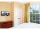 Inviting bedroom with a flat-screen TV and natural light at 1375 Tuscana Ln # 1405, Davenport, FL 33896
