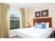 Bright bedroom featuring a queen-sized bed and a large window at 1375 Tuscana Ln # 1405, Davenport, FL 33896