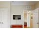 Bedroom with a TV on the wall and view into a seating area at 1375 Tuscana Ln # 1405, Davenport, FL 33896