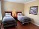 Bedroom featuring two twin-sized beds and matching night stands on top of wood floors at 1375 Tuscana Ln # 1405, Davenport, FL 33896