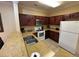 The kitchen is equipped with white appliances, wood cabinets, and a spacious countertop at 1375 Tuscana Ln # 1405, Davenport, FL 33896