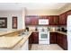 Well-equipped kitchen with granite countertops and white appliances in the Toscana community at 1375 Tuscana Ln # 1405, Davenport, FL 33896