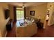 A cozy living room with neutral tones, wood floors, a ceiling fan, and a comfortable sectional sofa at 1375 Tuscana Ln # 1405, Davenport, FL 33896
