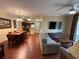 A stylish living space featuring wood floors, an open layout, and seamless transition to the kitchen and dining areas at 1375 Tuscana Ln # 1405, Davenport, FL 33896