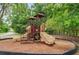 A colorful playground with slides and climbing structures sits on a wood-chip base at 1375 Tuscana Ln # 1405, Davenport, FL 33896