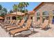 Relaxing poolside setting with lounge chairs, palm trees, and a view of the clubhouse at 1375 Tuscana Ln # 1405, Davenport, FL 33896
