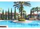 Stunning pool area with lush landscaping, clear blue water, and lounge chairs for relaxation at 1375 Tuscana Ln # 1405, Davenport, FL 33896
