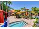 Inviting pool area with a hot tub, orange umbrellas, and plenty of seating for lounging at 1375 Tuscana Ln # 1405, Davenport, FL 33896