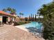 Beautiful community pool surrounded by lush landscaping and nearby lounge chairs at 1375 Tuscana Ln # 1405, Davenport, FL 33896