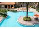 Expansive pool area featuring lounge chairs, tables, and vibrant orange umbrellas for shade and comfort at 1375 Tuscana Ln # 1405, Davenport, FL 33896