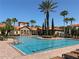 Community pool featuring ample seating and mature tropical landscaping at 1375 Tuscana Ln # 1405, Davenport, FL 33896