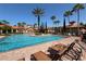 Exterior shot of an outdoor pool featuring lounge chairs and lush landscaping at 1375 Tuscana Ln # 1405, Davenport, FL 33896