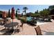 Outdoor pool with tables, umbrellas, and chairs in the surrounding area at 1375 Tuscana Ln # 1405, Davenport, FL 33896