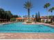 Large swimming pool with lounge chairs and landscaped surroundings at 1375 Tuscana Ln # 1405, Davenport, FL 33896