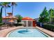Fun splash pad area with an orange mushroom water feature surrounded by a gated pool deck at 1375 Tuscana Ln # 1405, Davenport, FL 33896