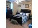 Traditional bedroom featuring a dark wood sleigh bed and matching dresser, creating a cozy aesthetic at 13838 Fairway Island Dr # 1418, Orlando, FL 32837