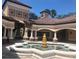 Community clubhouse featuring water fountain, stucco walls and covered walkway at 13838 Fairway Island Dr # 1418, Orlando, FL 32837