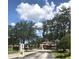 Entrance gate to the villas with well-manicured trees and bushes at 13838 Fairway Island Dr # 1418, Orlando, FL 32837