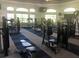 Community gym with modern exercise equipment and multiple windows at 13838 Fairway Island Dr # 1418, Orlando, FL 32837