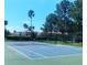 Community tennis court with view of community buildings in the background at 13838 Fairway Island Dr # 1418, Orlando, FL 32837