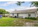View of the home's backyard with a small patio and lawn at 1640 Marks St, Kissimmee, FL 34746