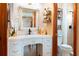Bathroom vanity area with a large mirror, counter space, and a toilet area, offering space and functionality at 1640 Marks St, Kissimmee, FL 34746