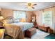 Comfortable bedroom features a decorative bed, windows, and antique dressers, creating an inviting atmosphere at 1640 Marks St, Kissimmee, FL 34746