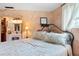 Relaxing bedroom boasts a wrought iron bed, painted walls, and an ensuite bathroom, blending comfort with style at 1640 Marks St, Kissimmee, FL 34746