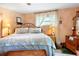 Inviting bedroom features a stylish iron bed, end tables, and soft lighting, offering a cozy retreat at 1640 Marks St, Kissimmee, FL 34746