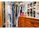 Walk-in closet with an organized rack of clothes, built-in shelving, and drawers, maximizing storage space at 1640 Marks St, Kissimmee, FL 34746
