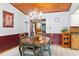 Traditional dining room featuring wood-paneled ceilings, a decorative chandelier, and comfortable seating at 1640 Marks St, Kissimmee, FL 34746