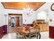 Traditional dining room showcases a wood table, chandelier, wood ceiling, and hardwood floors at 1640 Marks St, Kissimmee, FL 34746