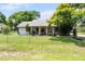 Attractive single-story home boasts a green lawn, fenced yard and mature landscaping at 1640 Marks St, Kissimmee, FL 34746