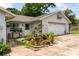 Charming home featuring landscaped front yard with various potted plants and a garage at 1640 Marks St, Kissimmee, FL 34746