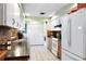 Well-lit kitchen with white appliances, cabinets, and brick backsplash at 1640 Marks St, Kissimmee, FL 34746