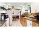Bright kitchen featuring a combination of white and wood cabinets and brick backsplash at 1640 Marks St, Kissimmee, FL 34746