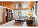 Cozy living room with wooden ceiling, plush sofa, and large patterned rug at 1640 Marks St, Kissimmee, FL 34746