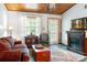 Inviting living room featuring a wood ceiling, fireplace, and comfortable seating at 1640 Marks St, Kissimmee, FL 34746