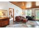 Inviting living room boasts a wood ceiling, comfortable seating, and lots of light at 1640 Marks St, Kissimmee, FL 34746