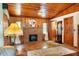 Warm living room featuring a brick fireplace, wooden ceiling, and comfortable seating at 1640 Marks St, Kissimmee, FL 34746