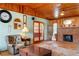 Comfortable living room featuring a brick fireplace, wooden ceiling, and plush seating at 1640 Marks St, Kissimmee, FL 34746