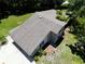 Aerial view of a home with a well-maintained roof, stone accents and lush green surroundings at 1843 Harbor Blvd, Kissimmee, FL 34744