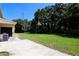 View of the large backyard and partially covered patio with an AC unit visible at 1843 Harbor Blvd, Kissimmee, FL 34744