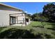 Large backyard with unfinished deck and partially covered patio at 1843 Harbor Blvd, Kissimmee, FL 34744